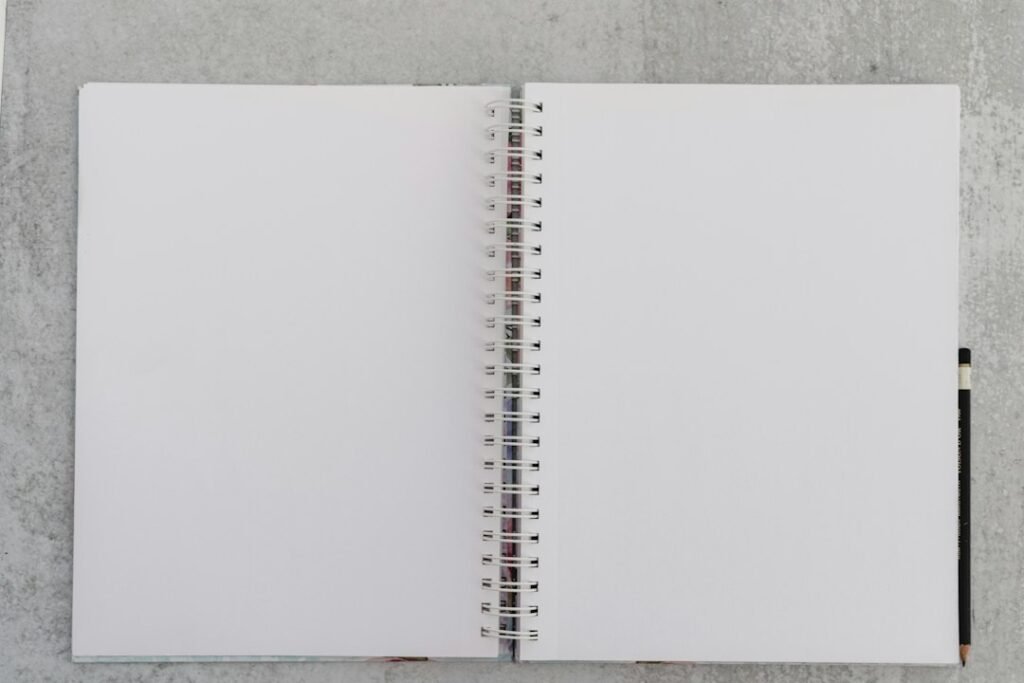 A variety of school notebooks with different page counts displayed on a desk, showcasing their covers and page layouts.