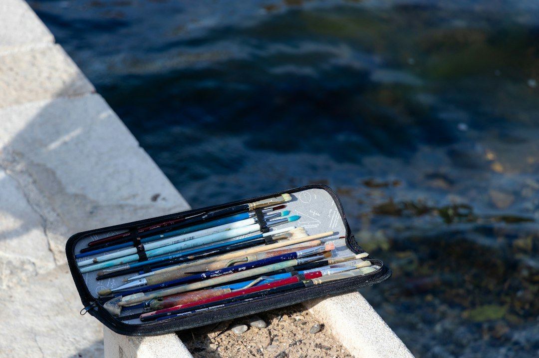 a bunch of pencils sitting in a case on a ledge
