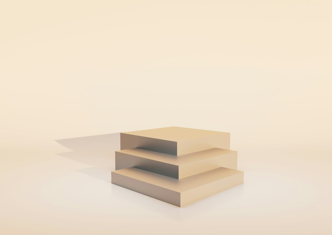 Three stacked beige cubes on a plain background
