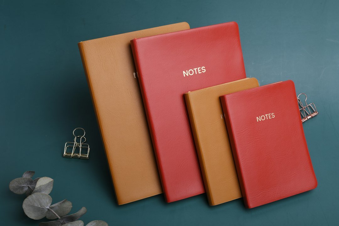 three notebooks sitting next to each other on a table
